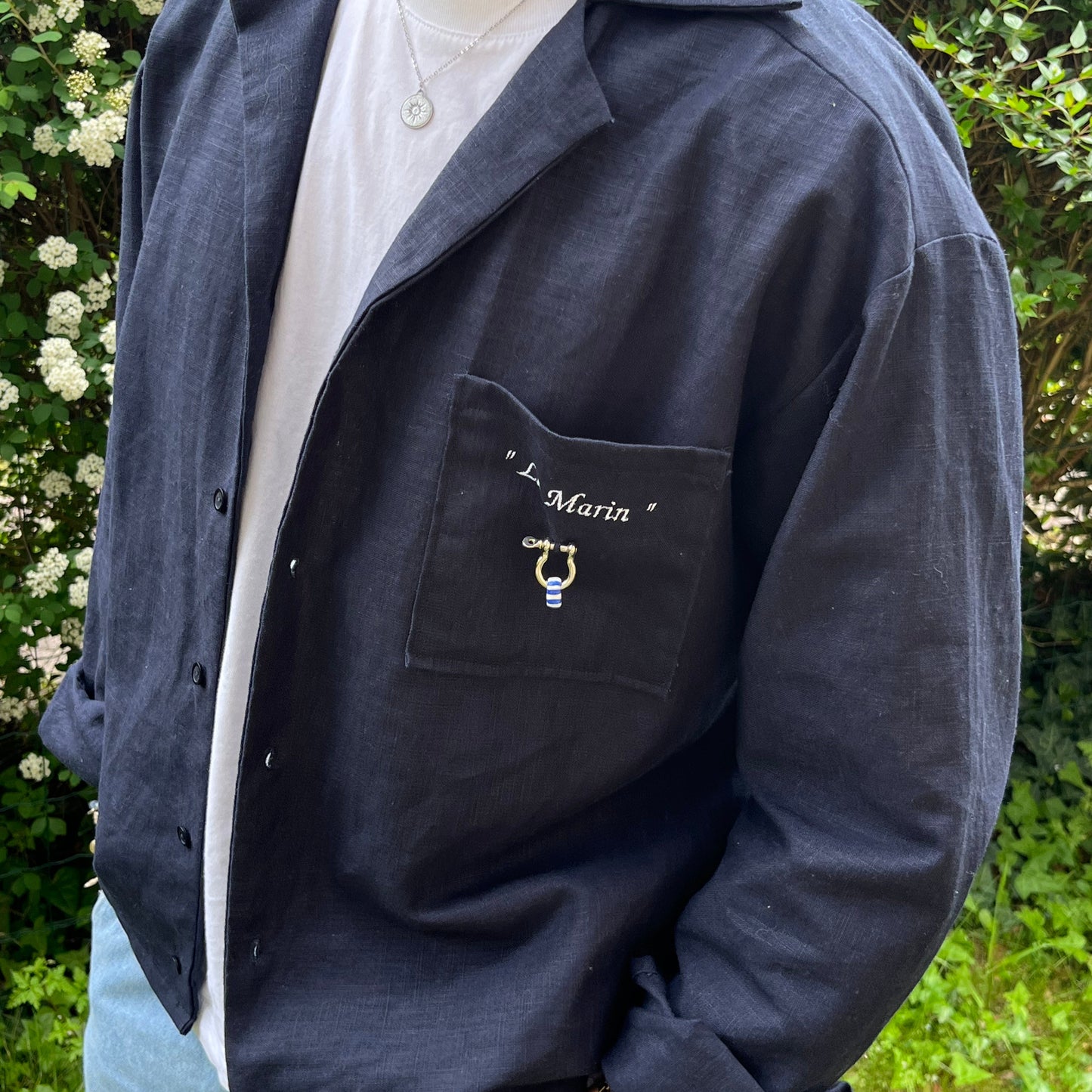 homme portant chemise ouverte col en v avec t shirt blanc pose décontractée